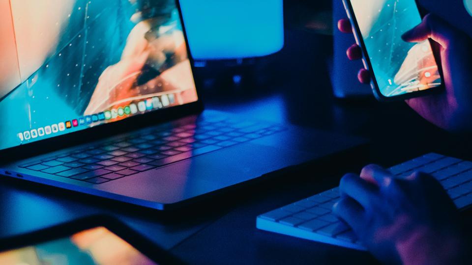 Teaser image person using laptop and smartphone